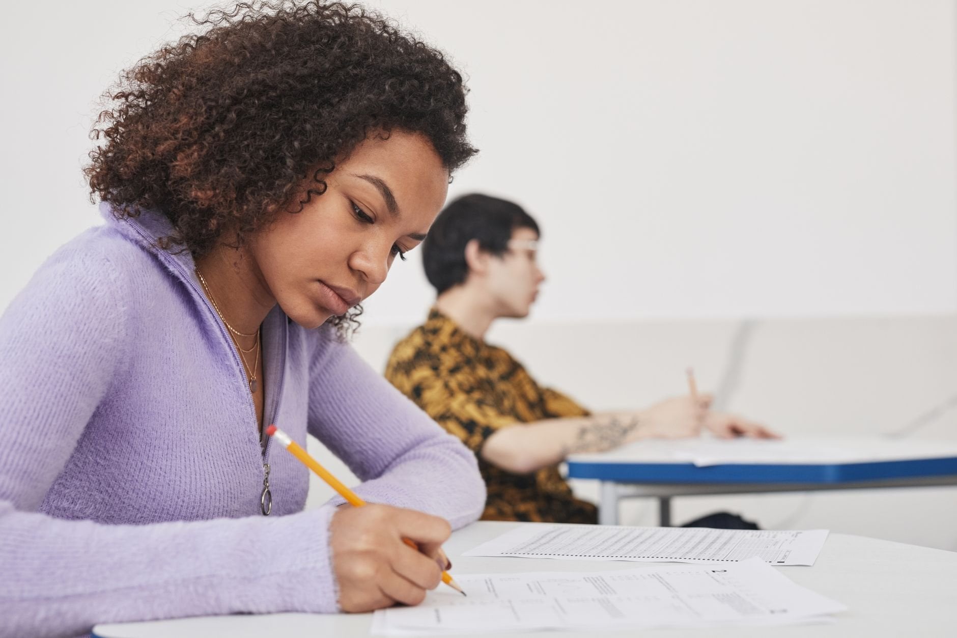Young students concentrating on exams in a classroom, emphasising focus and education